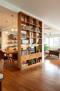 a living room filled with lots of furniture and bookshelves