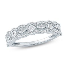 a white gold wedding ring with diamonds on it's sides and an intricate design