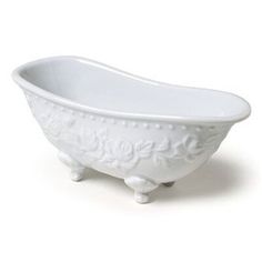 a white bath tub sitting on top of a white floor