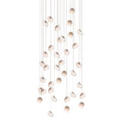 a white chandelier with many balls hanging from it's sides and one light fixture in the middle