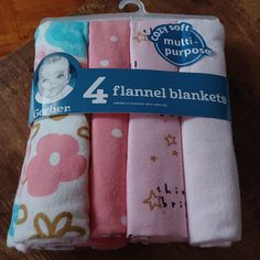 four baby blankets in pink, blue and white with an image of a baby's face on them