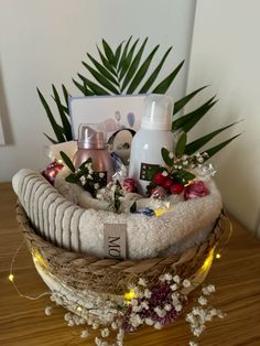 a basket filled with personal care items on top of a wooden table next to a plant