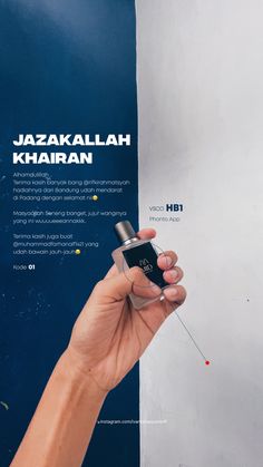 a hand holding an electronic device in front of a blue and white wall with the words jazakakalalah khairan written on it