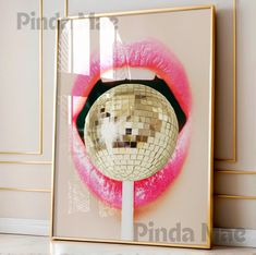 a mirror with a disco ball in the middle of it and pink lipstick around it