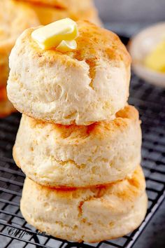 three biscuits stacked on top of each other with butter and jelly in the middle, sitting on a cooling rack