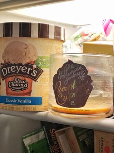 ice cream in a glass container on the shelf next to other food and drink items