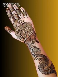 a woman's hand with henna tattoos on it