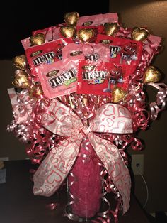 a vase filled with candy and candies on top of a table