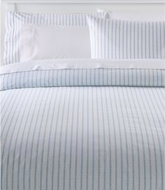 a bed with blue and white striped sheets