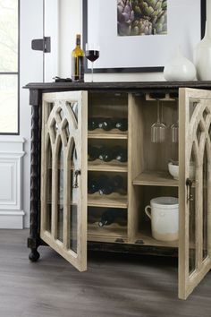 a cabinet with wine bottles and glasses in it