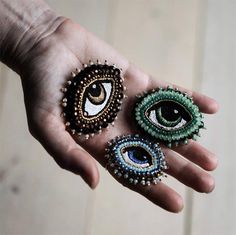 two pairs of eye rings in the palm of someone's hand