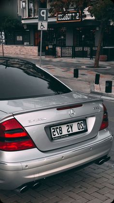 a silver mercedes cls parked on the street