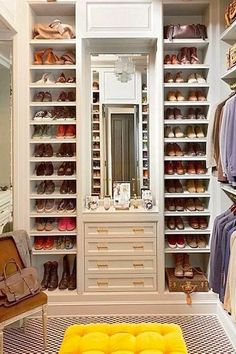 a walk in closet filled with lots of shoes