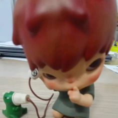 a little boy with red hair is listening to his earbuds