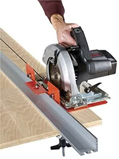 a man using a circular saw to cut wood planks with a miter attachment