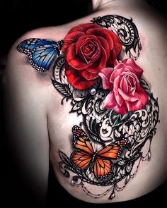 a woman's back with roses and butterflies on it