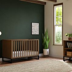 a baby crib in the corner of a room with a potted plant next to it