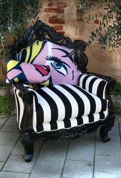 a striped chair with a stuffed animal sitting on it's back in front of a brick wall