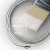 a close up of a paint brush on top of a white container with silver trim