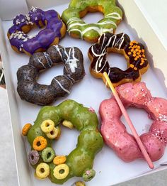 a box filled with different flavored donuts