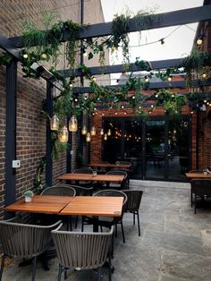 an outdoor dining area with wooden tables and chairs