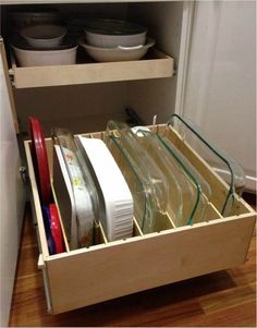 an open drawer with dishes and utensils in it