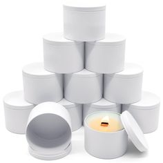 a stack of white boxes with a lit candle in the middle surrounded by smaller ones