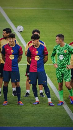 several soccer players are standing on the field