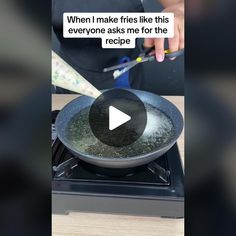 someone is frying something in a pan on the stove