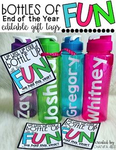 three colorful water bottles with the words fun on them sitting next to each other in front of a white fur surface