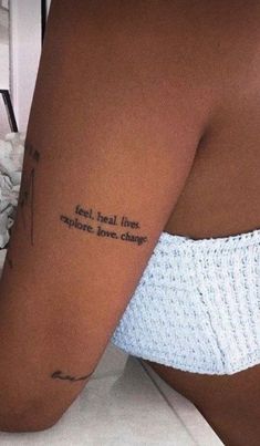 a woman with a tattoo on her arm that says eat real fine apples, love change