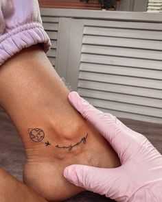 a person with a small tattoo on their foot that has the moon and stars in it