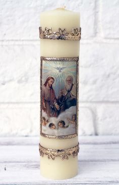 a candle with an image of jesus and mary on it