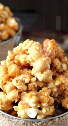 a bowl filled with popcorn sitting on top of a table next to another bowl full of popcorn