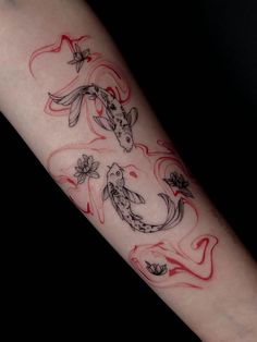 a tattoo design on the arm of a woman with koi fish and flowers in red ink