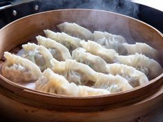 some dumplings are cooking in a wooden bowl