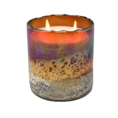 a candle that is sitting in front of a white background with an orange and blue flame