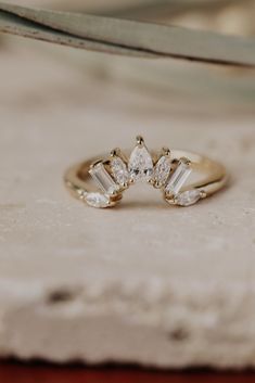 three stone engagement ring sitting on top of a piece of cloth