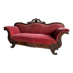 a red couch sitting on top of a wooden frame