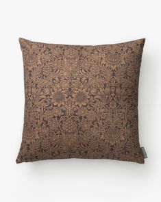 a brown pillow with an intricate design on it