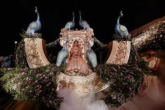 an elaborately decorated float with peacocks on it