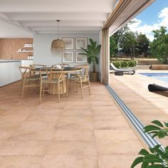 a dining room and kitchen area with pool in the background