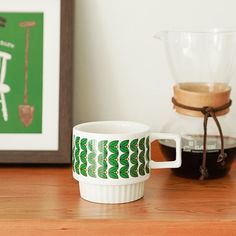 a coffee cup sitting on top of a wooden table