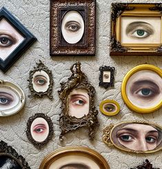 there are many different pictures on the wall with eyeballs in them and one is looking up