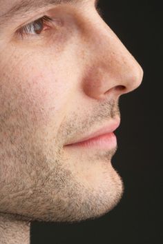 a close up view of a man's face and neck