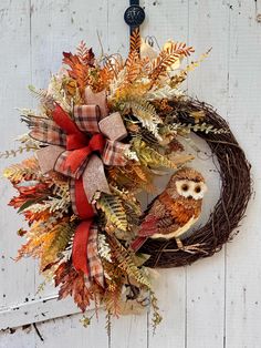 a wreath with an owl sitting on top of it