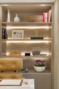 a room that has some shelves with books and vases on top of the shelves