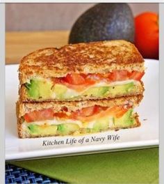 an image of a grilled sandwich on a plate with the caption, avocado mozzarella and tomato grilled cheese