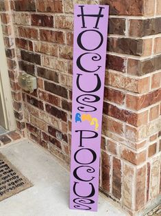 a purple sign with the word cococo written on it next to a brick wall