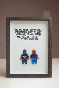 two legos are in a shadow box frame